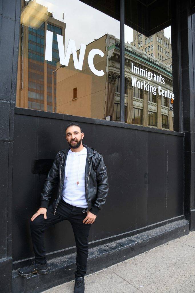Ayman standing in front of IWC offices