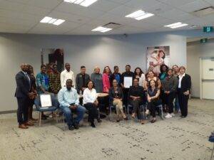 Participants, IWC staff and RBC team smiling at camera during closing ceremony for collaborative mentorship program.