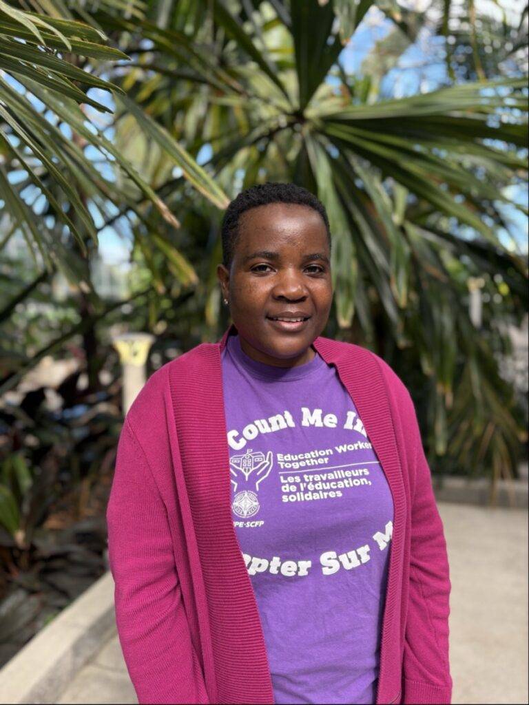 Moud smiling with greenery in background